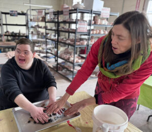 Linda Miller assisting a male individual at Bancroft