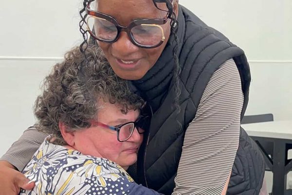 Bancroft's Velma Green embraces a female individual at a day program